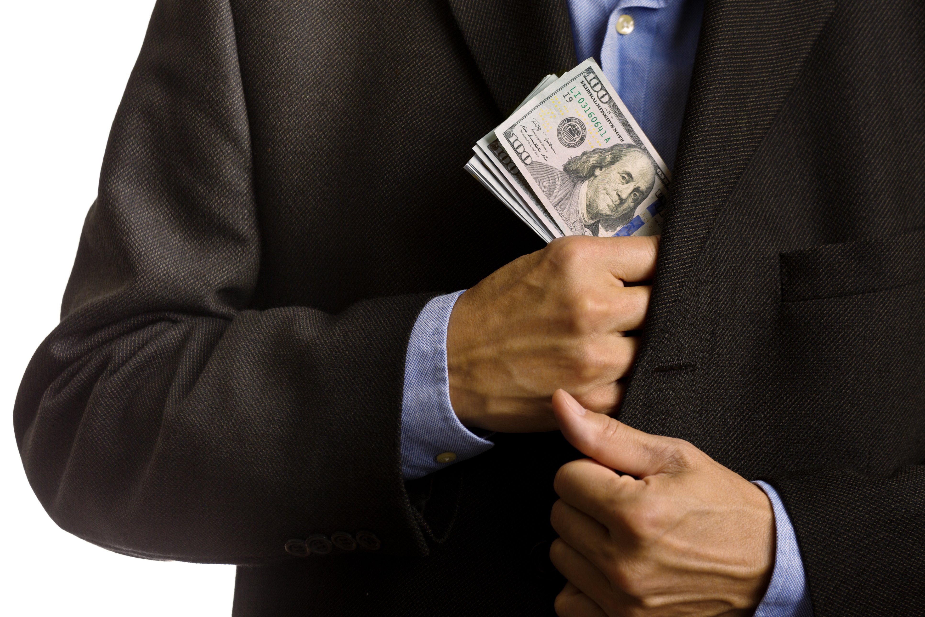 Corporate Businessman Slipping U.S. dollars Money into Suite Pocket